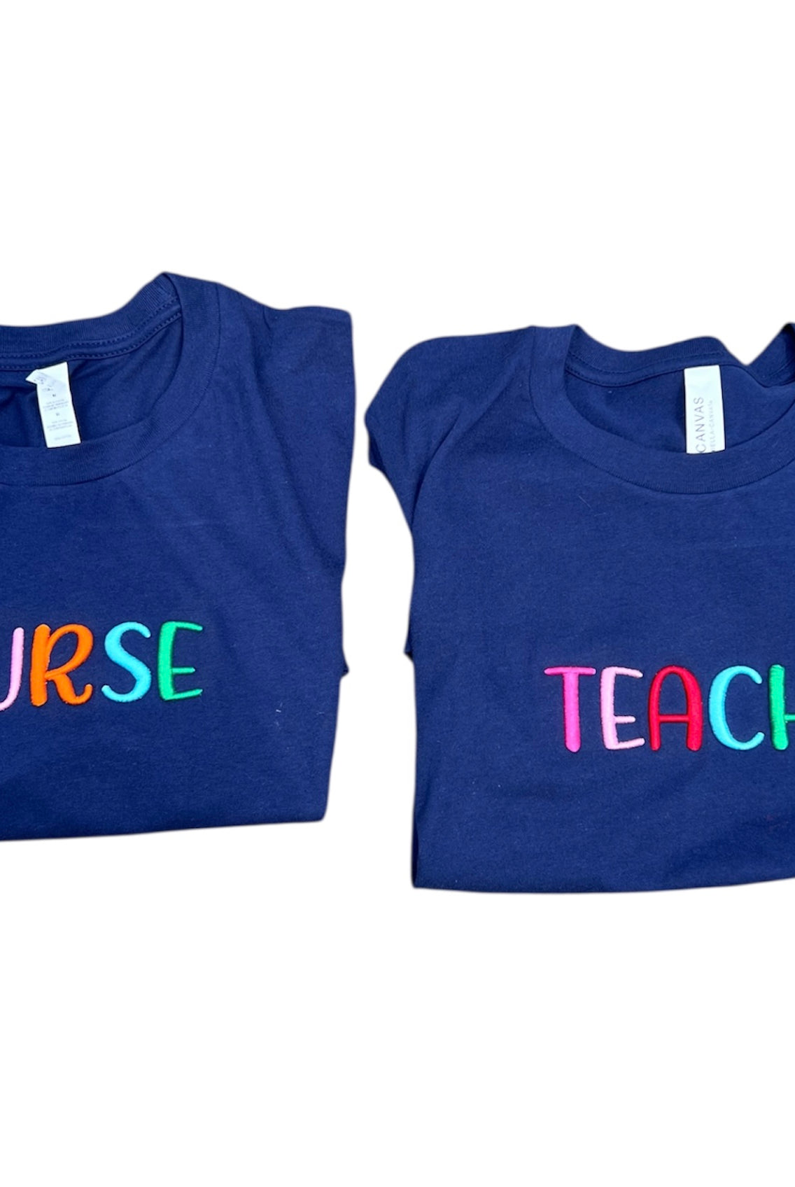 Two blue t-shirts with 'NURSE' and 'TEACH' text on a white background