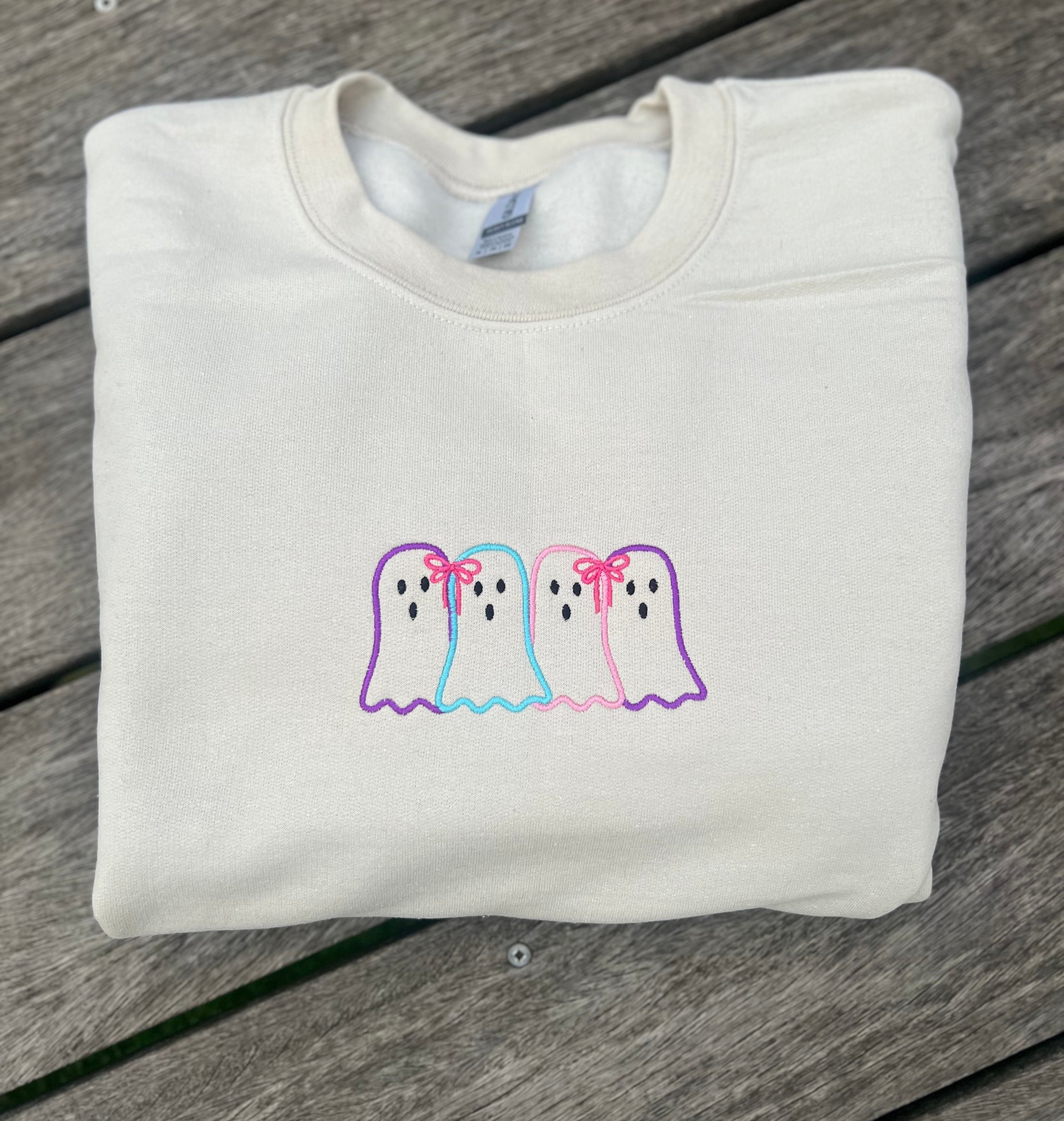 neutral colored sweatshirt with embroidered ghost outlines
