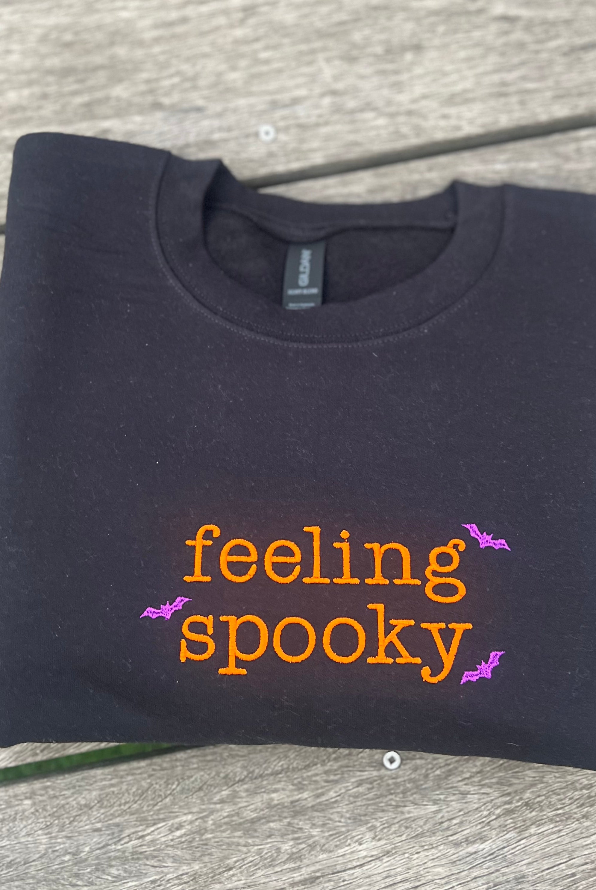 Black sweatshirt with 'feeling spooky' embroidered