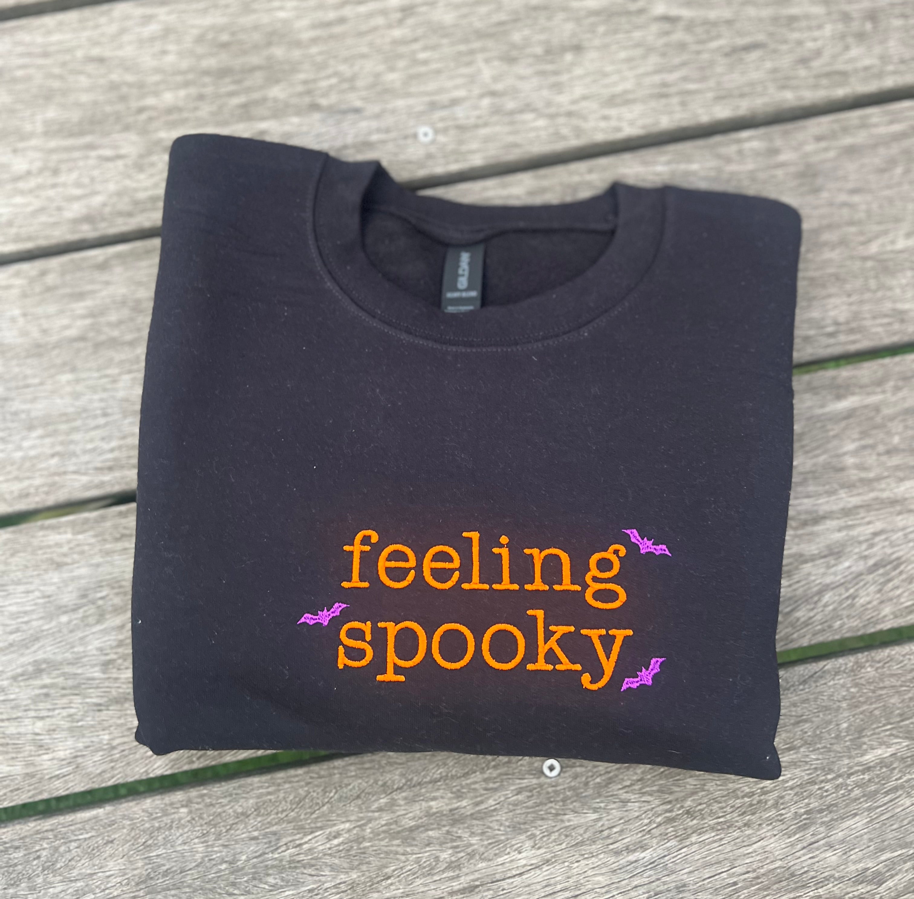 Black sweatshirt with 'feeling spooky' embroidered