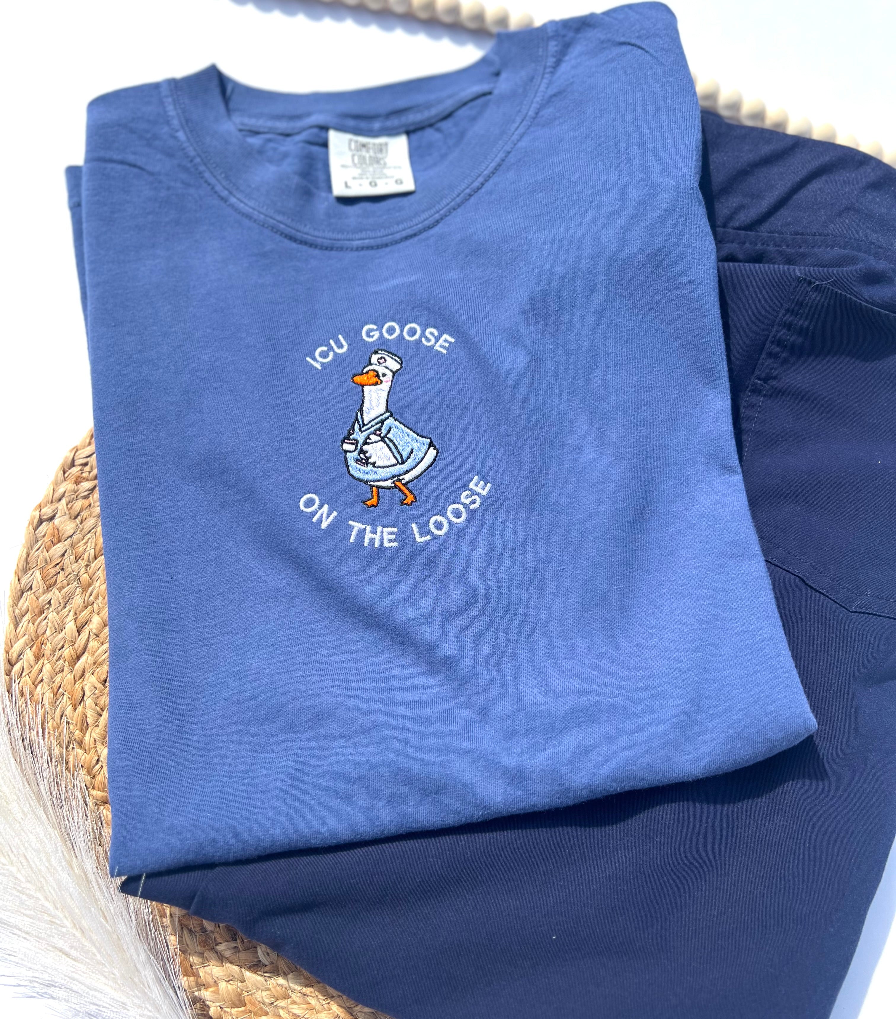 icu goose on the loose with a goose embroidered on a blue shirt