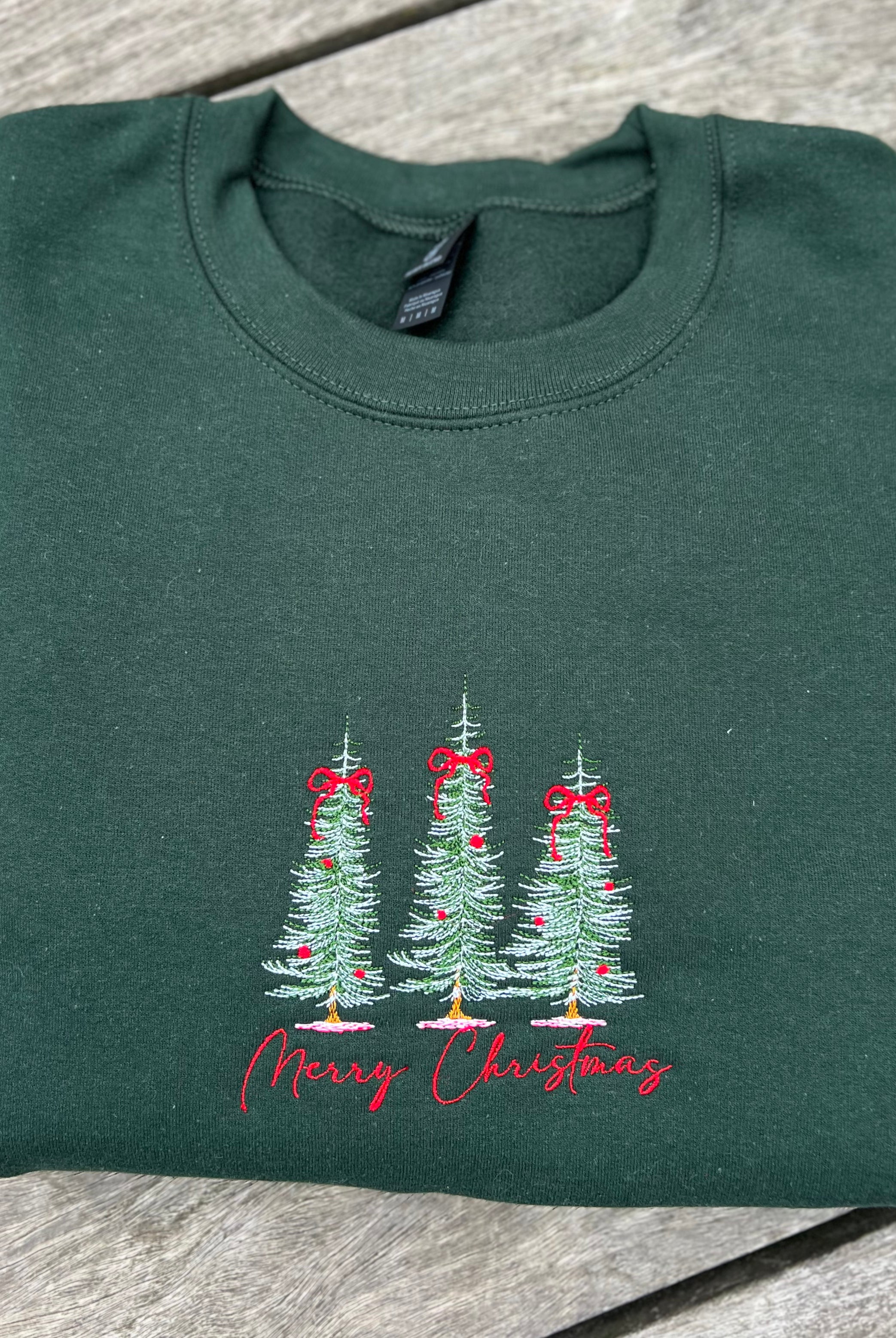 merry christmas embroidered sweatshirt with pine trees in forest green color
