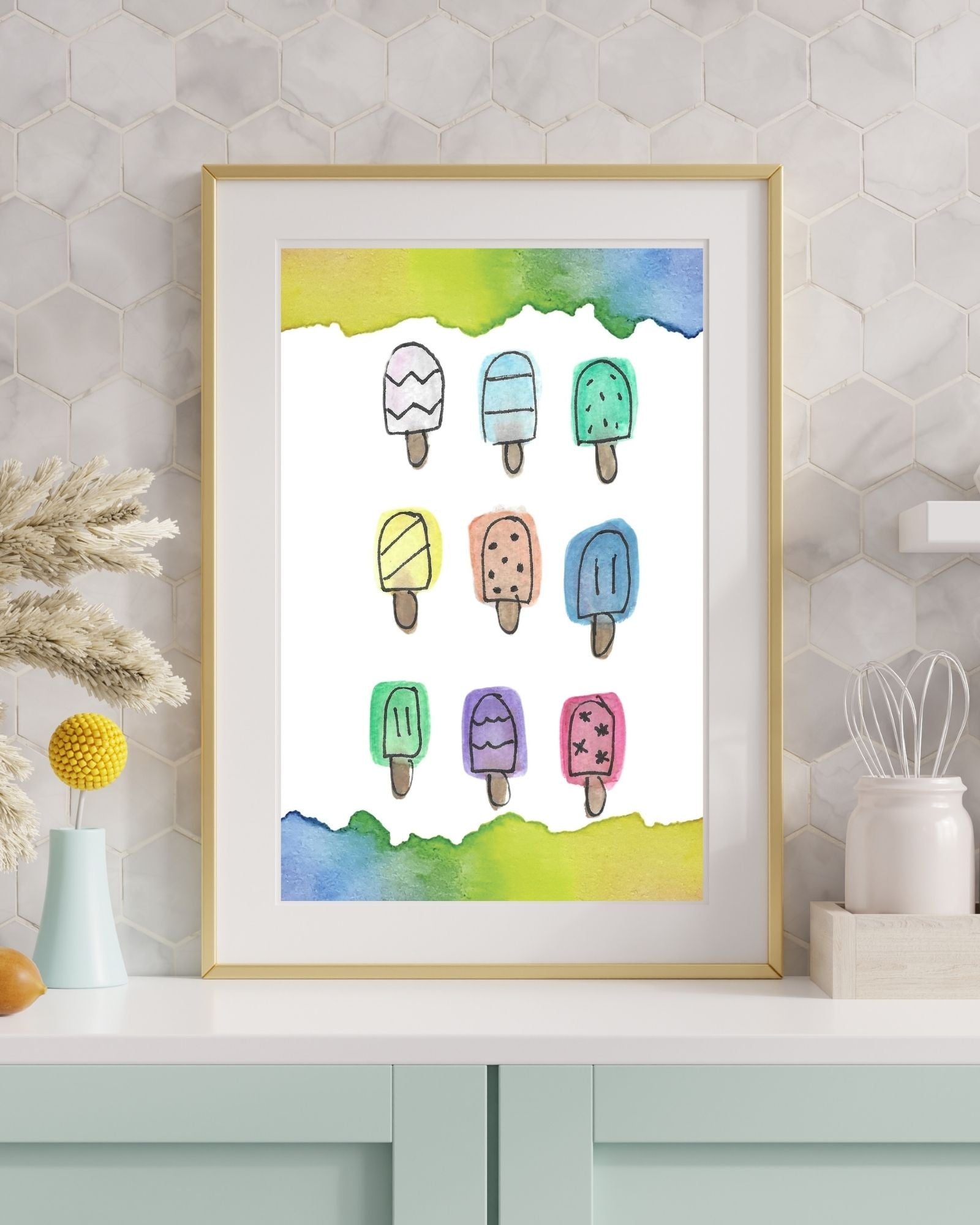 Framed artwork of colorful ice cream popsicles on a wall.