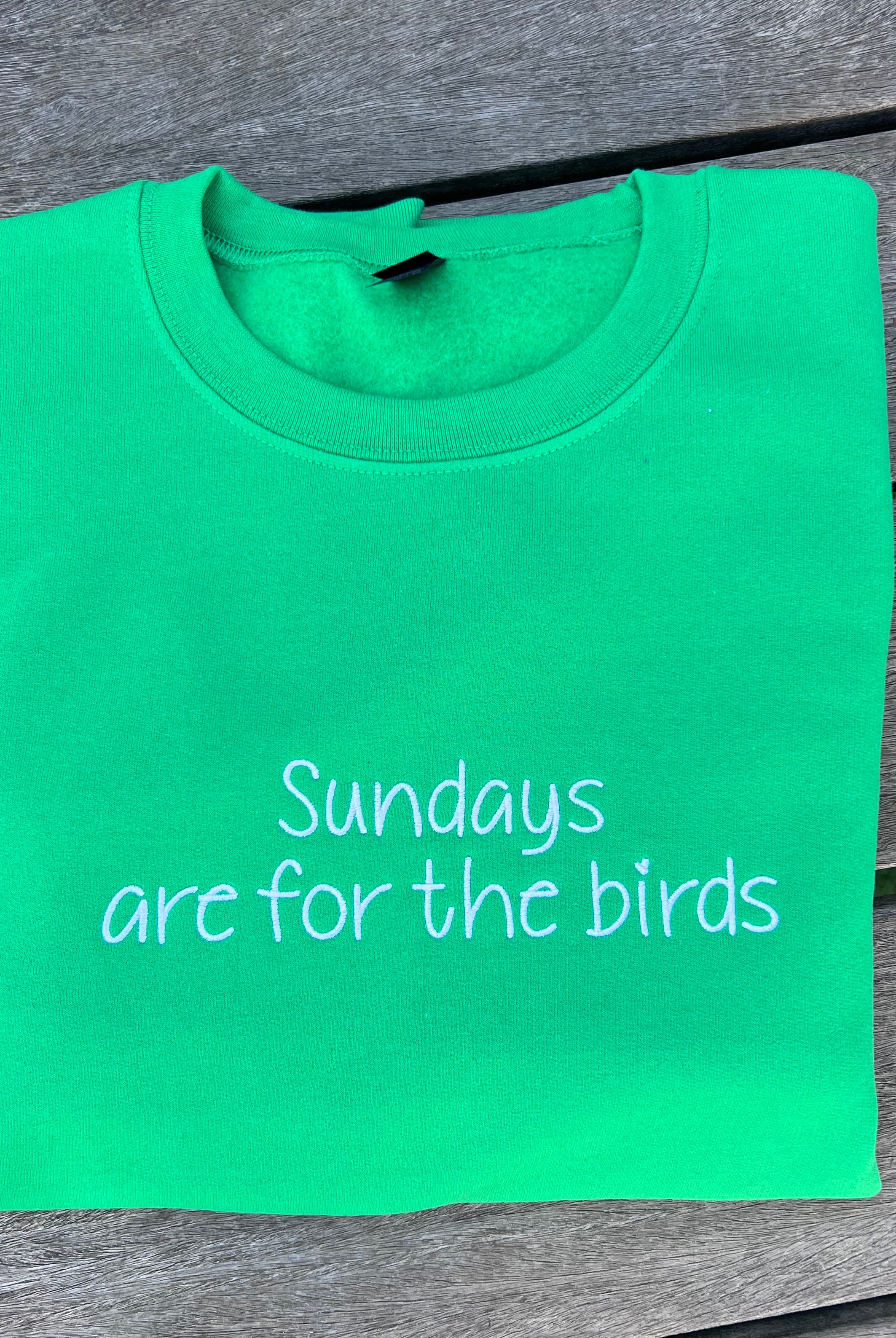 green sweatshirt with sundays are for the birds embroidered on it