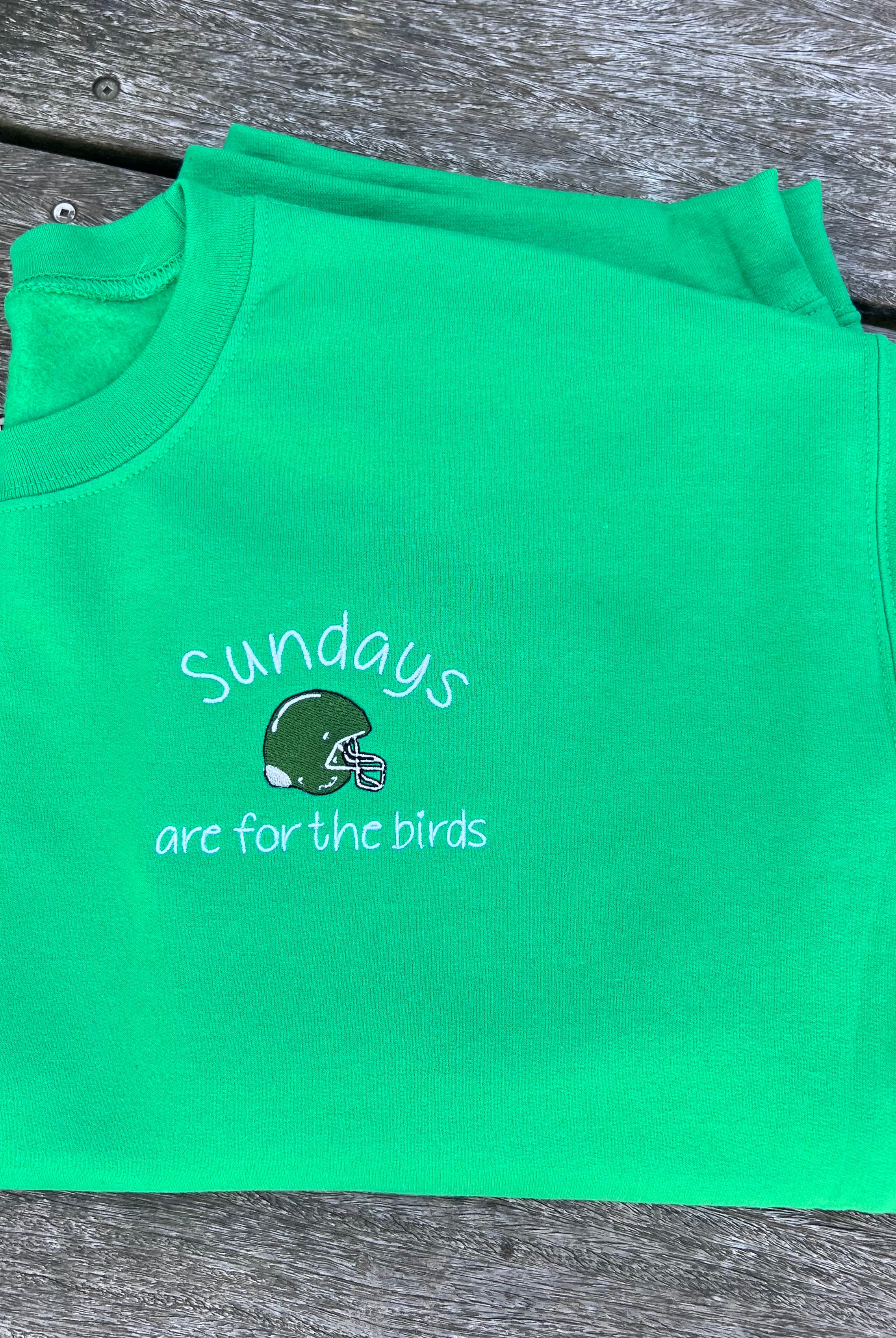 Green sweatshirt with sundays are for the birds and helmet design