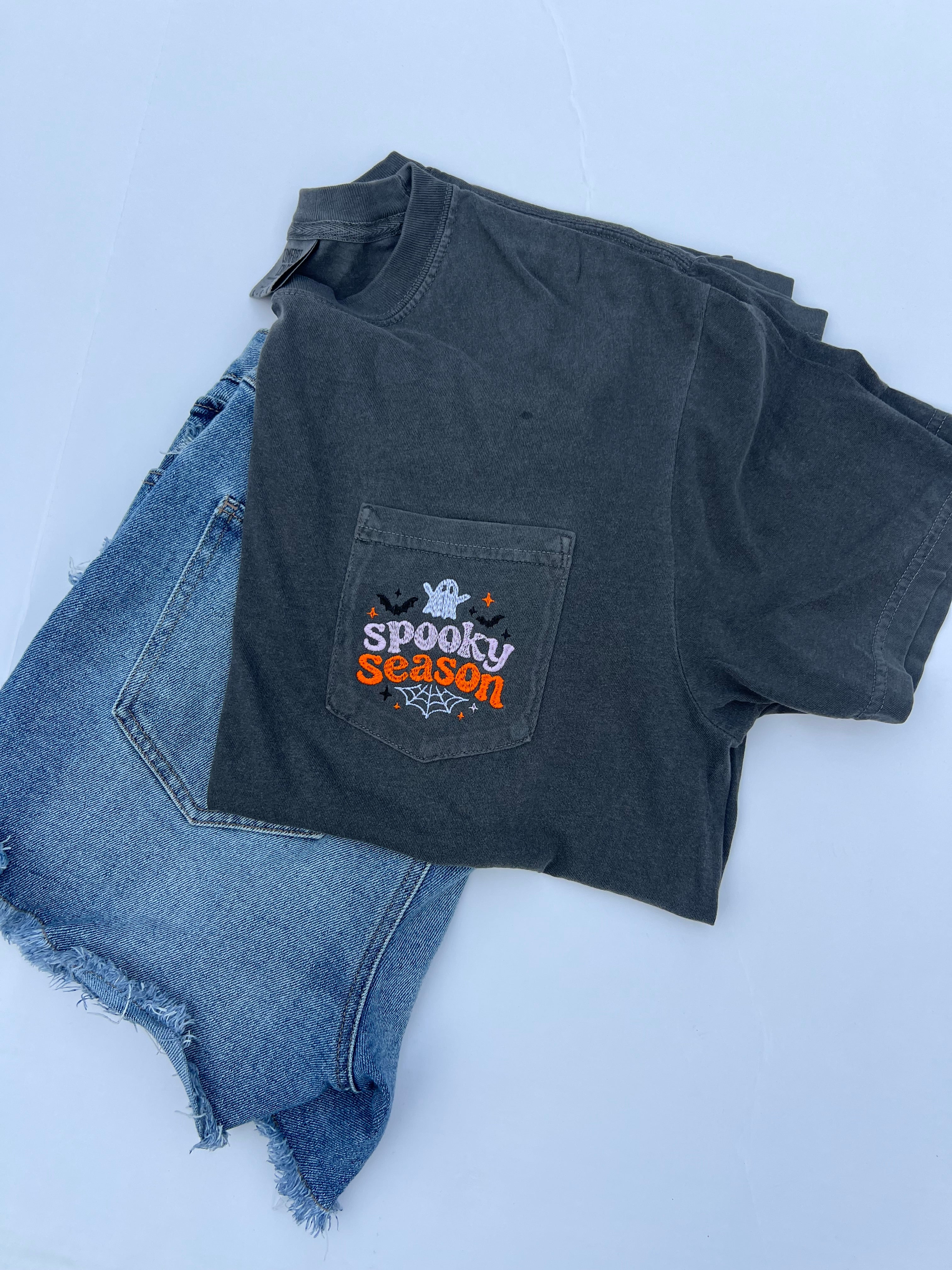 spooky season halloween design with ghost embroidered onto a comfort color pocket tshirt