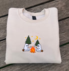 embroidered ghosts roasting smores at campfire on a neutral sweatshirt 