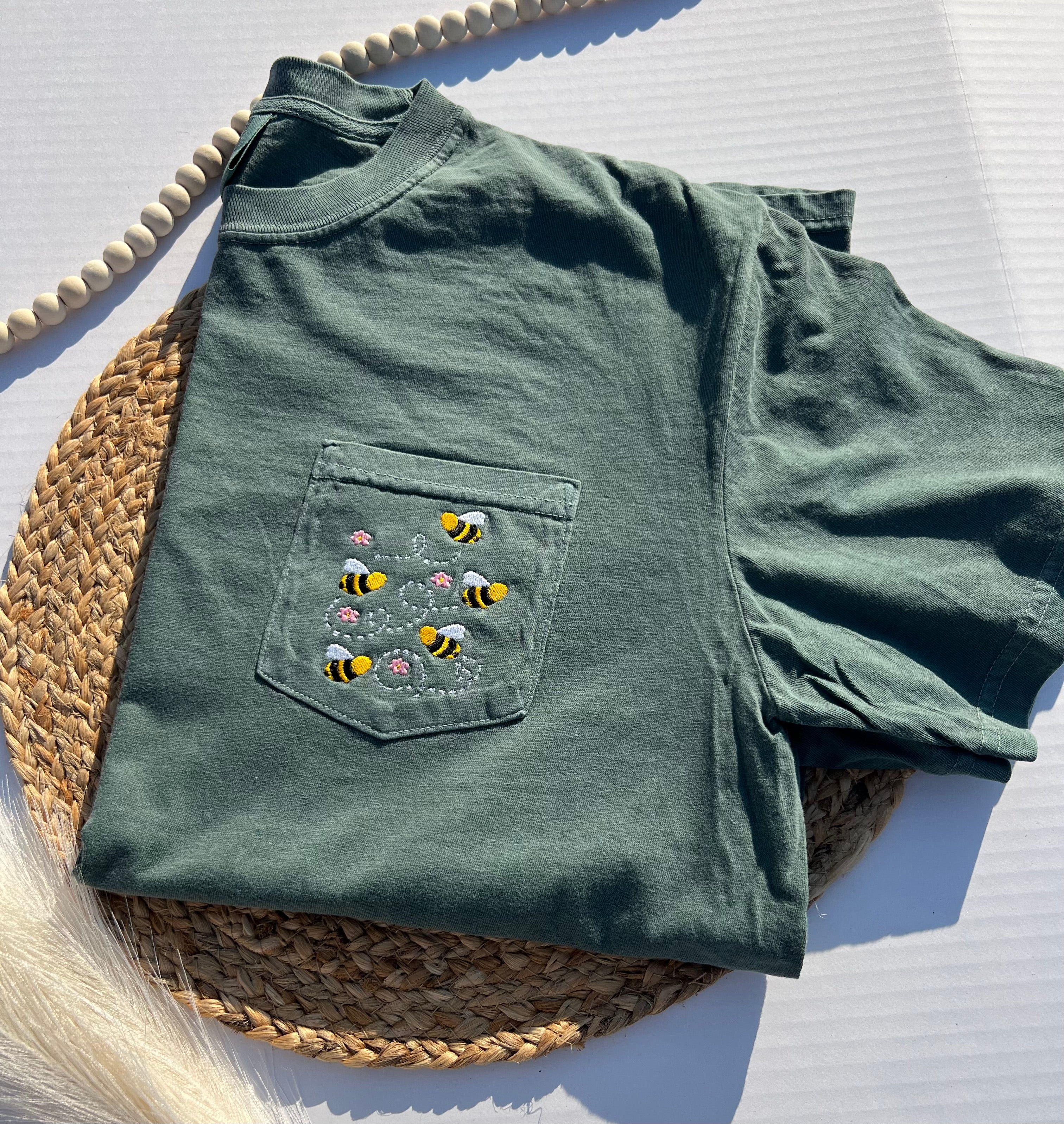 green tshirt with bumblebees embroidered on pocket