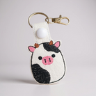 Cow-shaped keychain with a white background