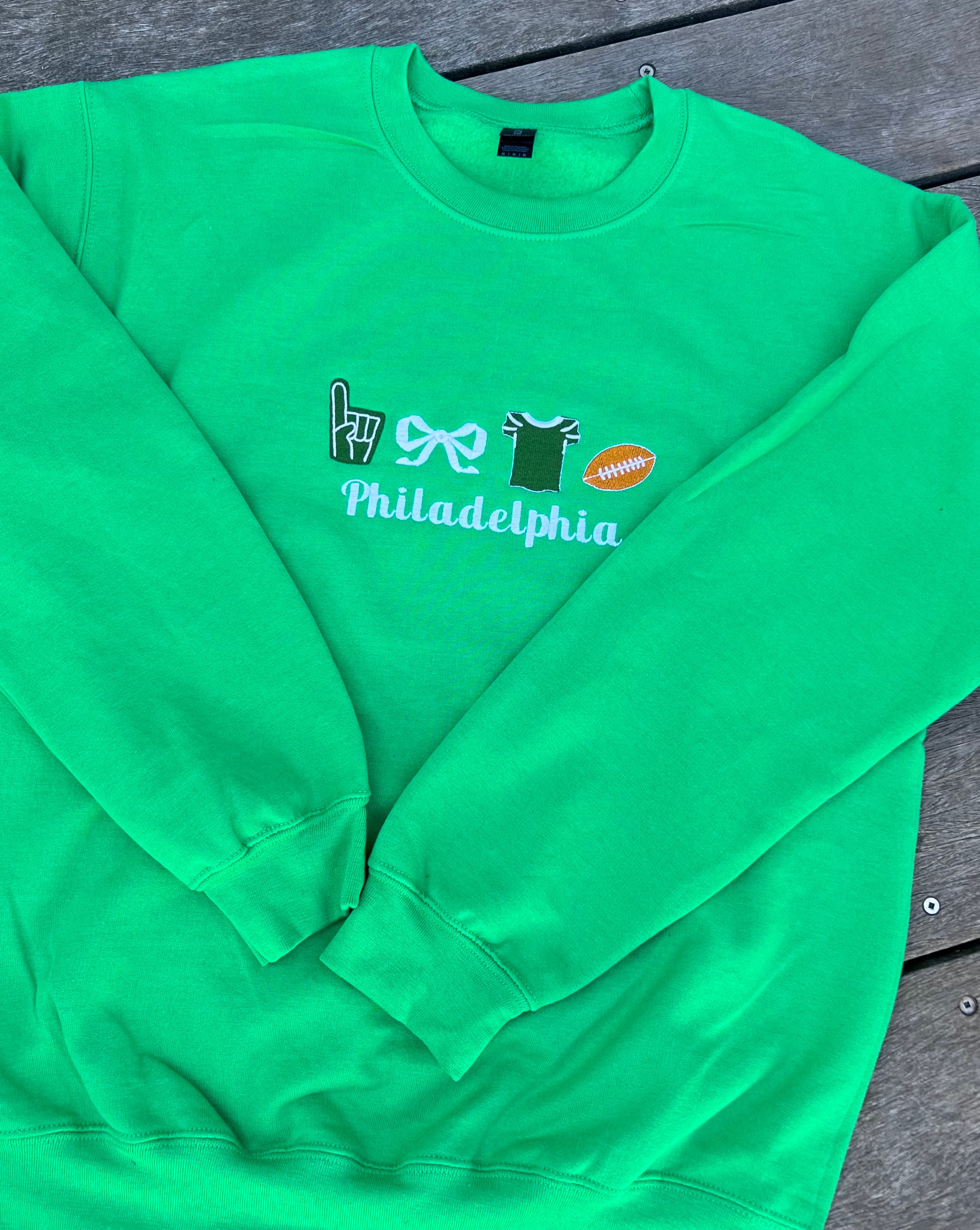 Green sweatshirt with philadelphia and football icons embroidered
