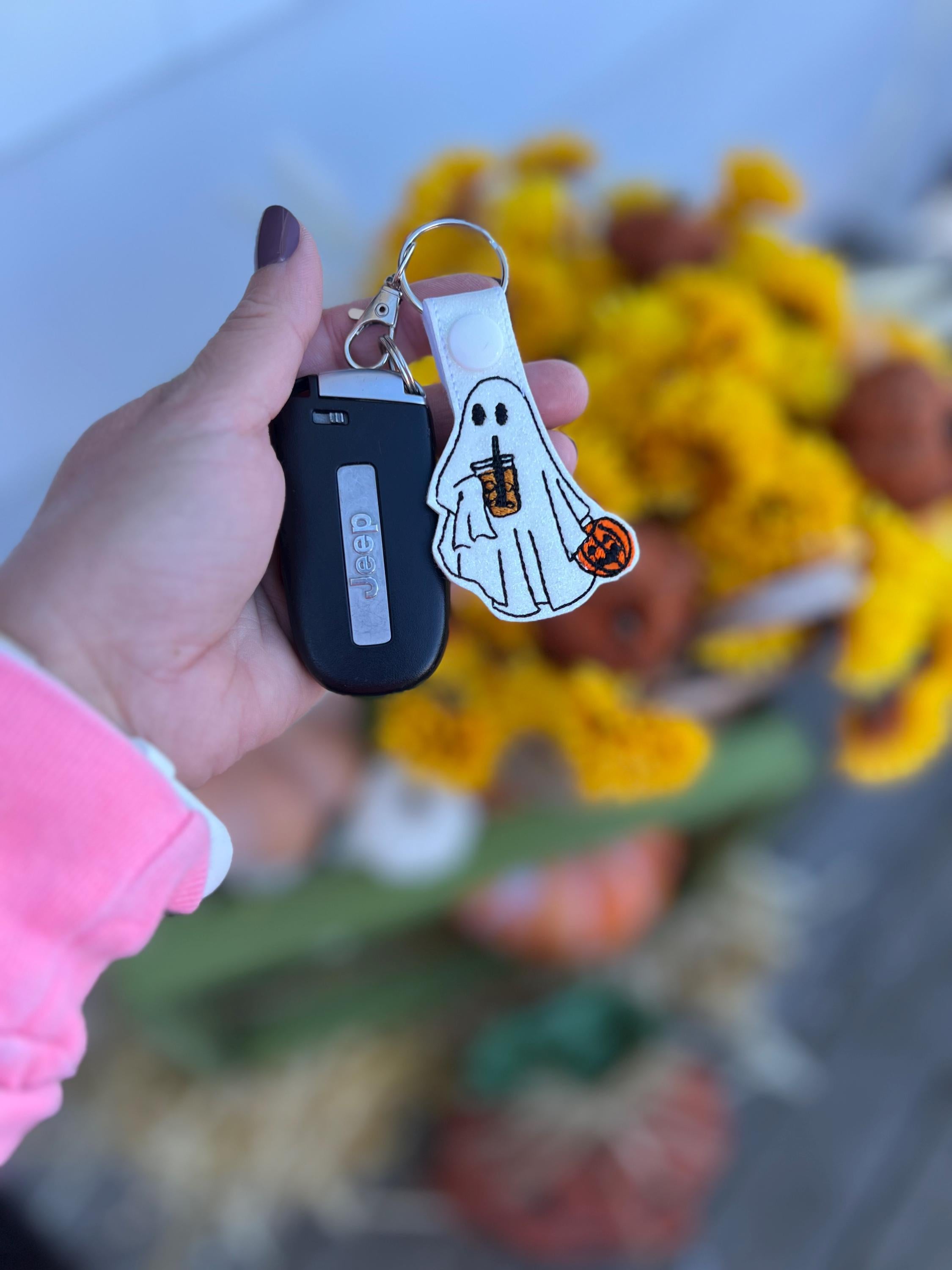 glitter keychain of a ghost holding an iced coffee