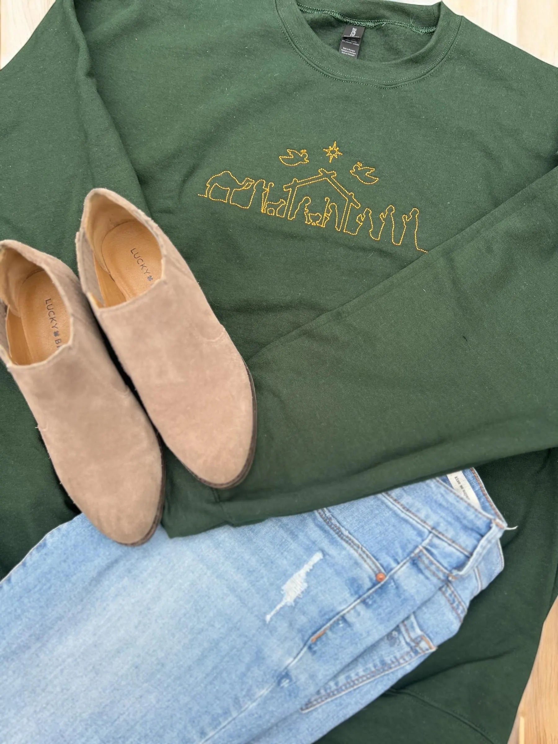 green sweatshirt with embroidered nativity scene for christmas