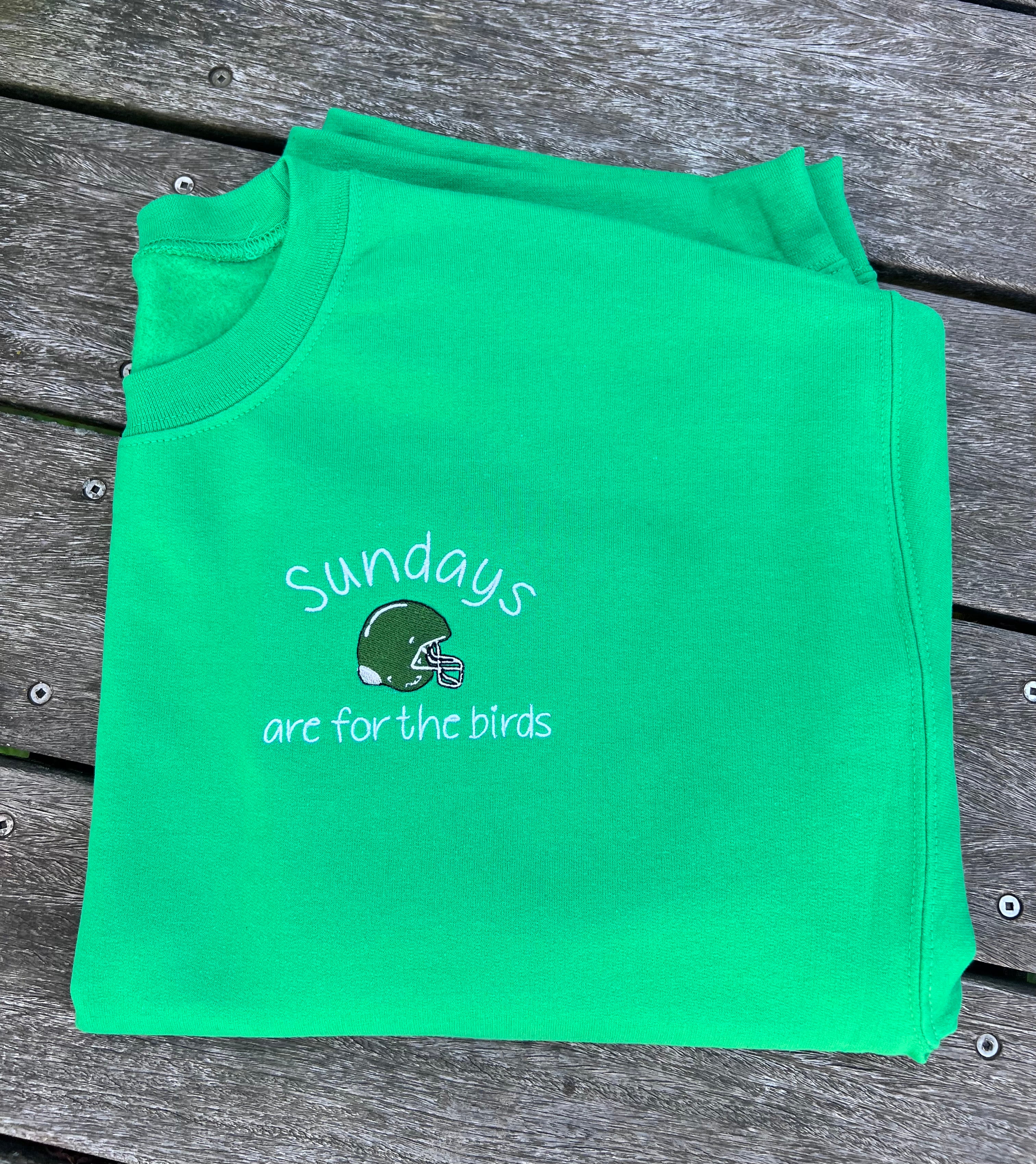 Green sweatshirt with sundays are for the birds and helmet design 